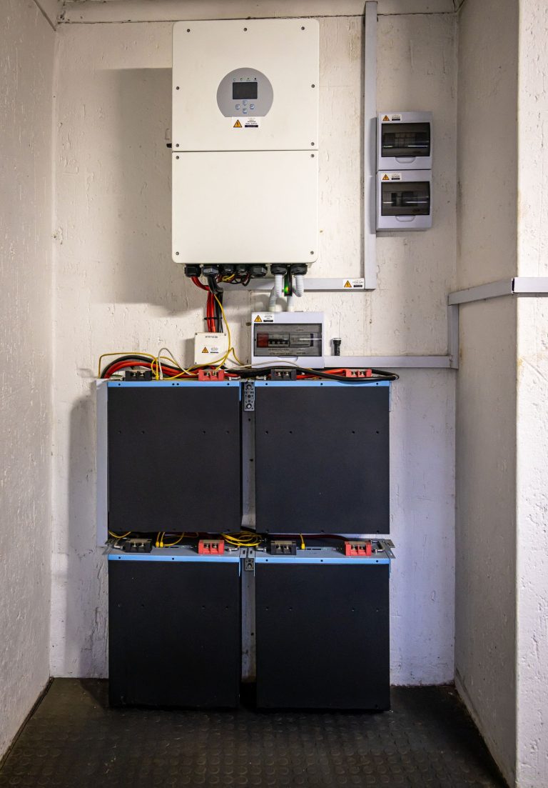 Home battery storage and hybrid inverter on a garage wall